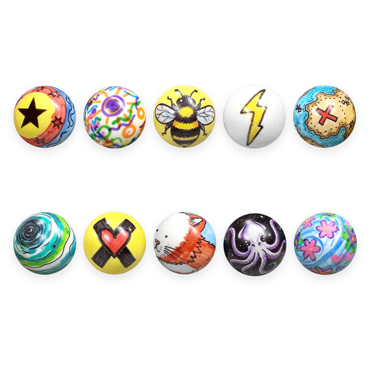 Ten Impact Marble Racing DIY marbles decorated with custom hand-drawn art including a star, bee, lightning bolt, treasure map, octopus, and flowers.